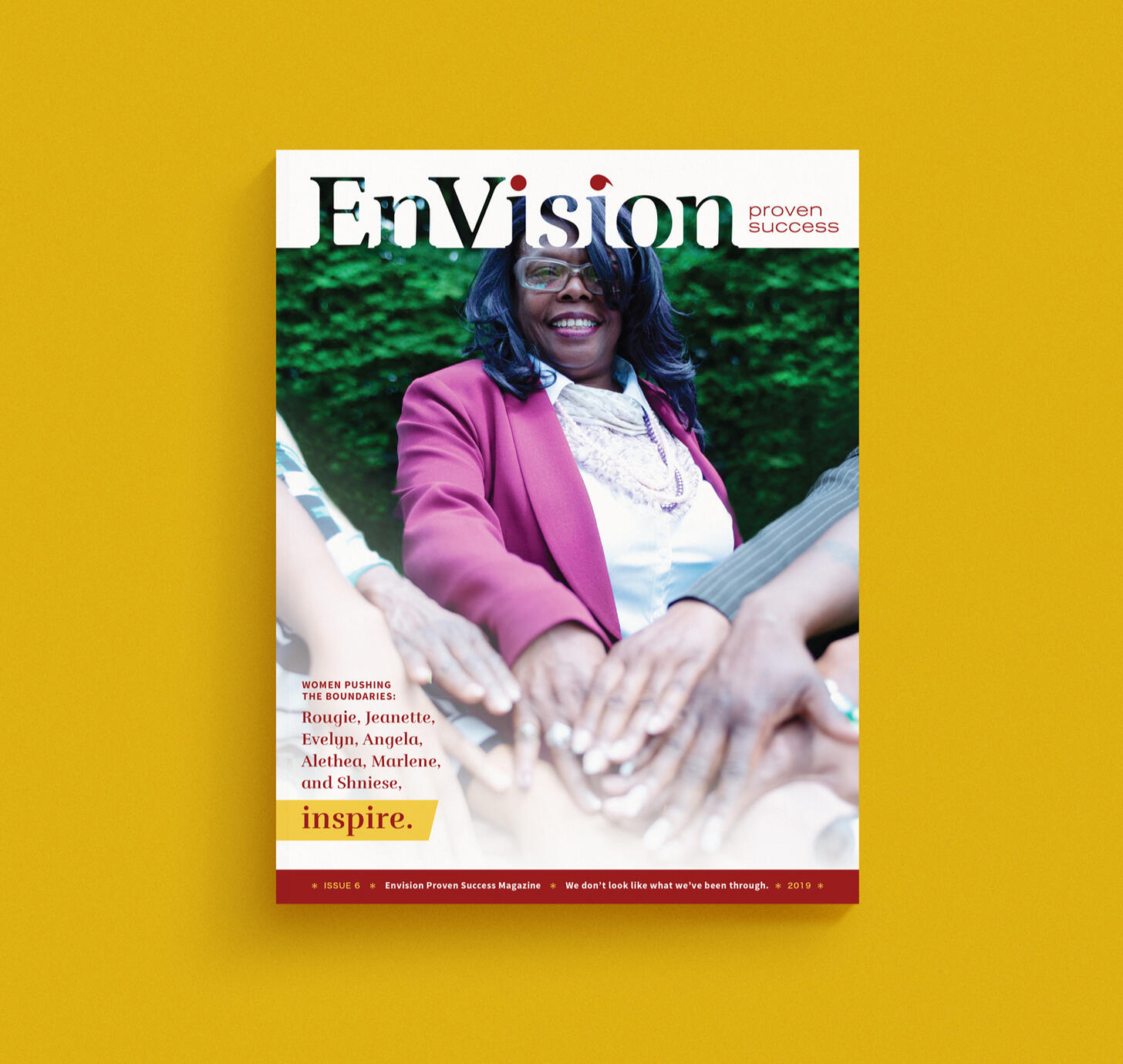 The EnVision Proven Success Magazine cover features a group of women with their hands "all in" and toward the viewer.